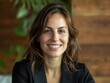 © Pat J. - Portrait of a smiling businesswoman in a modern office, showcasing her leadership qualities
