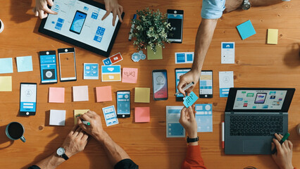 Top view of developer and designer shake hand together at meeting. Software developer handshake and working together with programmer to develop Ux Ui desifn for mobile phone interface. Convocation.