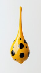 Yellow droplet shape with black polka dots against minimalist grey background