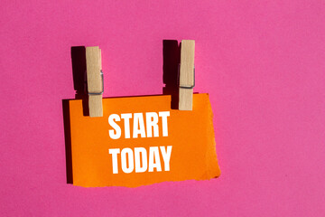 Start today message written on ripped torn orange paper piece with pink background. Conceptual start today symbol. Copy space.