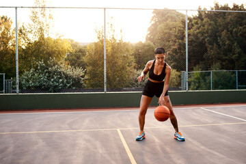 Wall Mural - Woman, sport and ball as ready on basketball court for challenge as player or athlete for training. Female person, warm up and outdoor for competition, match and game in physical activity or exercise