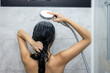 © leungchopan - Woman take shower and wash hair at bathroom