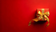 © Galeno - golden ribbon wrapped around small gift box bold red background minimal festive marketing design concept sale event graphics