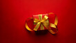 © Galeno - golden ribbon wrapped around small gift box bold red background minimal festive marketing design concept sale event graphics