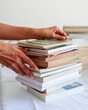 © Isolda - person holding stack of books