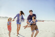 © Marko Geber - Happy family playing and running together on the beach