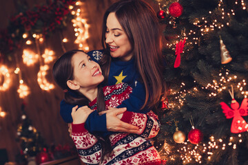 Wall Mural - Photo of two peaceful people mother daughter cuddle chatting new year xmas garland lights apartment indoors