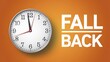 © IbragimovN - Fall back: daylight saving time adjustment with clock on orange background