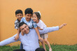 © Arlette - Single Dad with two brown latino sons and daughter spend time together and have fun to celebrate Father's Day in poverty
