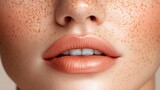 Closeup of woman's freckled face with nude lipstick.
