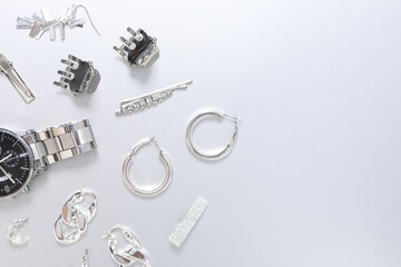 Female accessories in silver color on white background, space for text