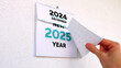 © Stockah - A man's hand tearing off the December page of a wall calendar followed by another announcing the arrival of the New Year 2025