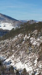 Wall Mural - Vertical Aerial video of Altai mountains with pine snowbound taiga forest in winter.