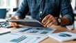 © Kevin - Executive Analyzing Data Insights on Tablet in Office