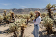© Julija - woman visiting Joshua Tree National park, enjoy Cholla cactus garden.