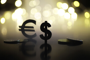 Wall Mural - Euro and Dollar Symbols with Coins on a Dark Background with Bokeh Lights