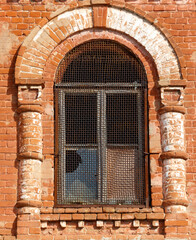 Wall Mural - A window with a metal frame and a hole in it