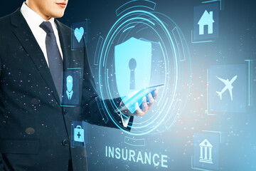 Wall Mural - Close up of businessman hand using mobile phone with creative life insurance hologram with padlock and other icons on blue background.