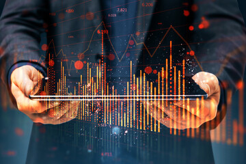 Wall Mural - Close up of businessman hand using tablet with falling red candlestick forex chart on blurry background. Crisis and market recession concept. Double exposure.