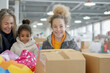 © Robert Kneschke - Family volunteering at a Christmas gift drive event