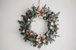 © Mykola - Merry Christmas Round. Modern Christmas Wreath Hanging on White Wall Background