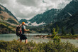 © Павел Чигирь - a tourist guy with a backpack looks at the beautiful mountains in Altai
