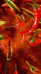 Poster - Super Slow Motion of Flying Colored Chilli Peppers. Black Background. Filmed on High Speed Cinema Camera, 1000 fps. Vertical Aspect Ratio.