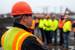 © CozyDigital - Foreman gives instructions to builders at construction site