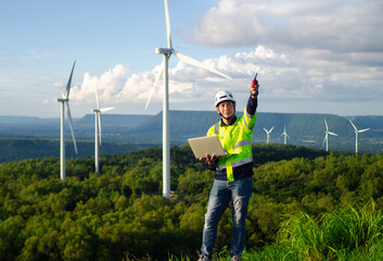 Male engineer working on wind turbines, wind farms or wind farms, clean energy sources, ecological technology for electricians, system alert