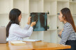 © Songsak C - Asian female doctor explaining lung x-ray film of a female patient at the hospital.
