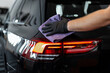 © alones - Professional man washes car and wipes with microfiber. Detailing and car wash