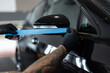 © alones - professional man tapes a car with masking tape before polishing. Preparation before polishing