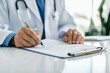 © Ирина Щукина - A doctor is writing on a clipboard
