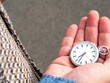 © Wirestock - Hand holding a classic pocket watch.