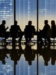 © Tadeusz - Silhouetted group of professionals in a meeting during twilight cityscape.