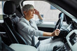 © Davor - Senior businesswoman driving a car