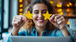 © Robert Kneschke - Customer holding gold star rating in front of laptop in a cafe