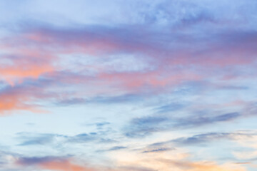 Wall Mural - A beautiful sky tinted by the sun leaving vibrant shades of gold, pink, blue and multicolored. Clouds in the twilight evening and morning sky. Cloudy sky background in the evening, and during the day.