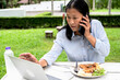 © Jack Tamrong - Busy Asian businesswoman working on computer laptop and eating on lunch time