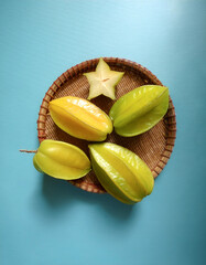 Wall Mural - Averrhoa carambola, starfruit fruit, isolated on a pastel blue