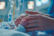 © EvgeniiaFreeman - Parent's hand holding newborn baby in hospital setting. World prematurity day, 17 november. Prematurity awareness month