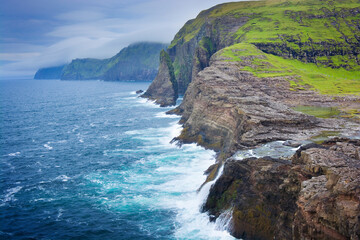 Bøsdalafossur waterfall in the Faroe Islands that flows from Leitisvatn lake into the Atlantic Ocean. It has a height of 30 meters