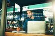 © peopleimages.com - Laptop, thinking and business man with notebook in cafe for writing ideas, online research and planning. Window, remote work and person on computer for internet, website and proposal in coffee shop