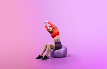 Full body length gaiety shot athletic and sporty young woman with fitness exercising ball in standing posture on isolated background. Healthy active and body care lifestyle.