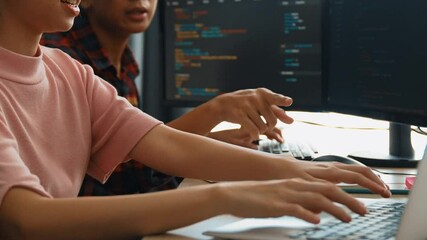 Slow motion back end software developer engineer for computer programming working together on debugging writing computing code, solving complex algorithms display on monitor in office. Burgeoning