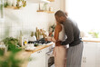 © Anastasiya - Happy african american couple and cooking with hug in kitchen for food preparation, nutrition and romantic meal at home. Smile, man and woman with stew or soup for balanced diet, .bonding and support