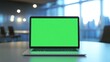 © sup - Laptop with Green Screen on a Table in an Office