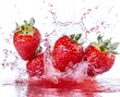 © BINTANGFUFUFAFA - Four fresh red strawberries splashing into clear water, creating a vibrant burst of color and energy.