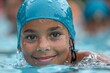 © Yuliia - A young athlete in a blue swim cap enjoys the water while warming up for an upcoming race