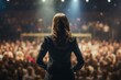 © Rawpixel.com - Back view of a motivational female speaker standing on stage audience concert adult.
